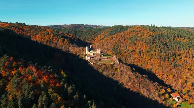 Aerail shot around Rochebaron Castle near Bas en Basset on a sunny day during fall season, Haute Loire departement, Auvergne Rhone Alpes region, France