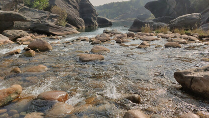 Clear stream flows between rocky hills in Islamabad