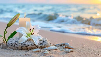Burning candle with white lily flower near a stone podium on sea sand beach with wave background.