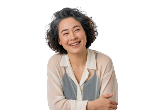 Mature asian woman with curly dark hair and grey streaks, smiling gently with arms crossed, isolated on transparent background
