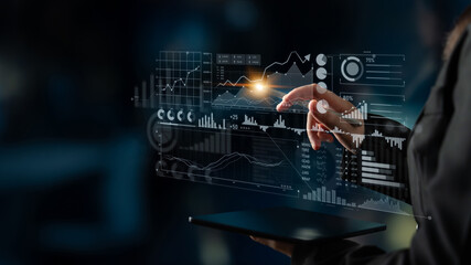 A professional user interacts with a futuristic touchscreen interface displaying dynamic business analytics and data visualizations, ideal for corporate analysis. Scalp