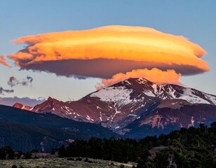 A majestic mountain range beneath a dramatic, fiery-hued lenticular cloud formation at sunset. Snow caps the peak