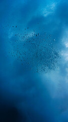 Floating beneath the wild ocean surface. Underwater photography. Below the wild surface- Rays of light through the waves. 