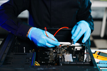Closeup of technician testing computer motherboard with multimeter in modern lab, representing precision, innovation, and professional electronic repair service.