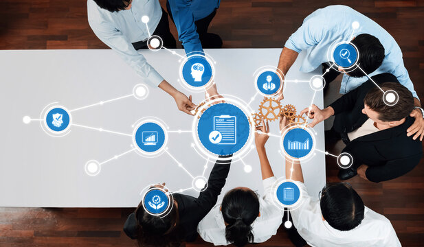 Aerial view of a diverse team collaborating in a business meeting, utilizing technology and innovative tools to enhance communication and drive strategic solutions. Amity - Powered by Adobe