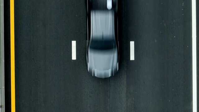 Aerial drone view of a newly paved asphalt road with a moving car, symbolizing infrastructure development, enhanced connectivity, and modern transportation for economic growth and progress.
