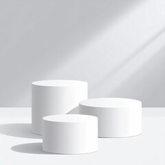 Three white cylinder stands, light shadows on gray background