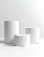 White cylindrical pedestals arranged against a white background