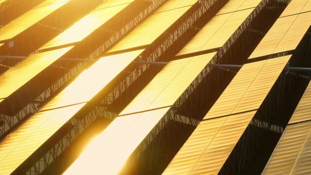 Aerial view of solar panels glowing under sunlight, symbolizing clean energy, sustainability, technology, innovation, climate action, eco-efficiency, progress, resilience, and global awareness.

