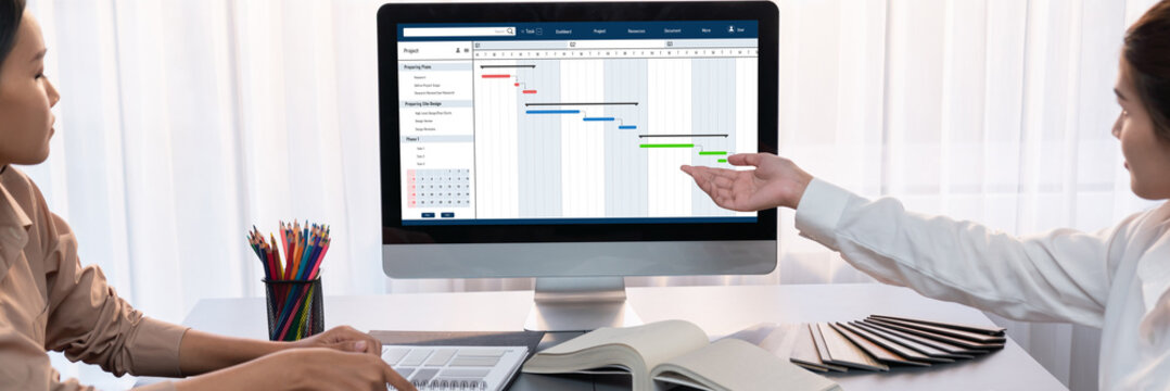 Project planning software for brisk business project management on the computer screen showing timeline chart of the team project