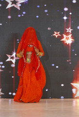 Portrait of an unidentified female artist performing classical dance in ethnic indian clothes.