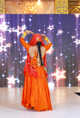 Portrait of an unidentified female artist performing classical dance in ethnic indian clothes.