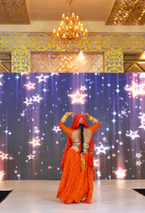 Portrait of an unidentified female artist performing classical dance in ethnic indian clothes.