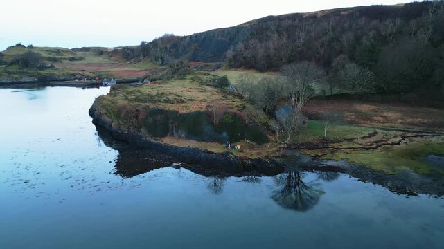 Aerial Drone Footage of a Seaside Bothy on a Scottish Loch, Isle of Lismore &mdash; Remote Stone Shelter, Rugged Coastline, Calm Water Reflections, and Dramatic Highlands Landscape in Soft Natural Light
