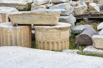 Close-up of ancient marble column fragments with ornate carvings in the Acropolis of Athens. Concept of history, architecture and restoration