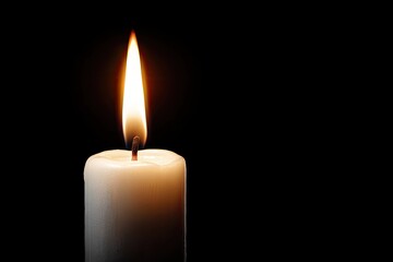 Single, warm candle with bright, flickering flame against a dark, stark background
