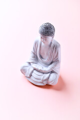 Meditating Buddha Statue on bright background. Soft focus. Copy space	