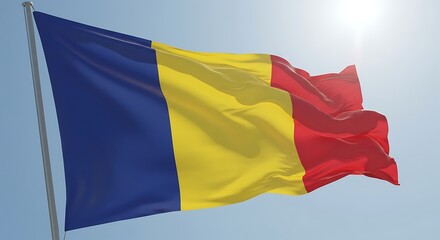 Romanian flag waving proudly against a clear blue sky on a bright sunny day, symbolizing national pride and patriotism.