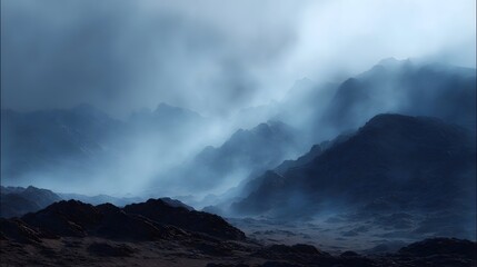 Dramatic mountain landscape shrouded in atmospheric fog and mist showcasing rugged barren terrain under a dark sky