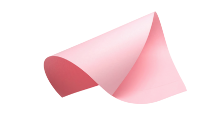 Pink paper sheet curls upward, catching light and shadow against a pure black background