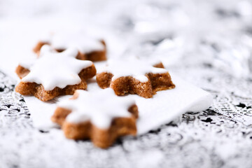 Christmas cookies (cinnamon stars) on bright background. Close up.