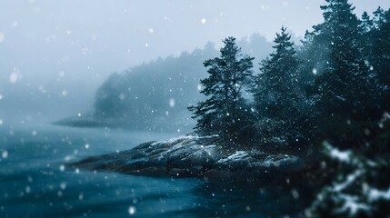 A serene winter landscape with snow falling over a coastal forest and calm water