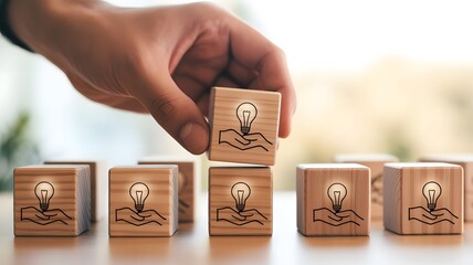 Creative Idea Concept with Hand and Light Bulb on Wooden Blocks