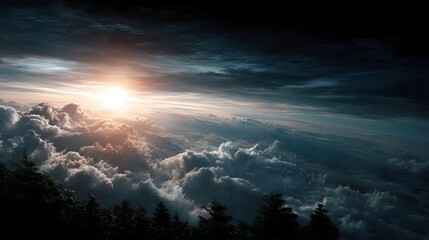 Fototapeta premium Majestic sunrise breaks through dramatic atmospheric clouds casting golden light over a vast ocean of clouds and a silhouetted mountain forest