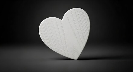 Woodgrained offwhite heart stands upright against a dark gray background creating a shadow on the surface