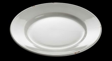 White cracked plate on a black background shows signs of wear and aging
