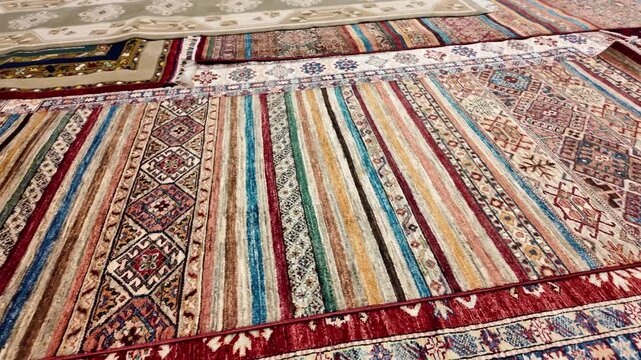 Turkish showroom rug sale as various patterns and material blends are exhibited on the floor