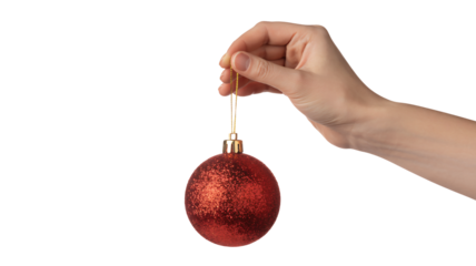 Elegant hand gracefully presents a sparkling red Christmas ornament, perfect for festive holiday decor and seasonal celebrations.