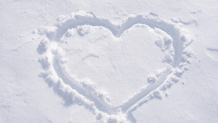 Heart on snowy ground. Winter romantic theme.