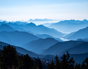 Fototapeta premium Layered blue mountain ranges fading into the distance at sunrise