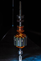 Electric motor rotor with metal structure and copper windings on dark background, futuristic industrial technology concept