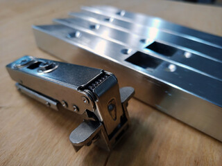 aluminum facade profile with inset hinge holes. furniture parts in production.