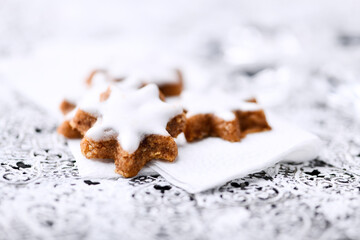 Christmas cookies (cinnamon stars) on bright background. Close up.	