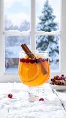 Warm spiced drink with orange and cinnamon in cozy winter setting