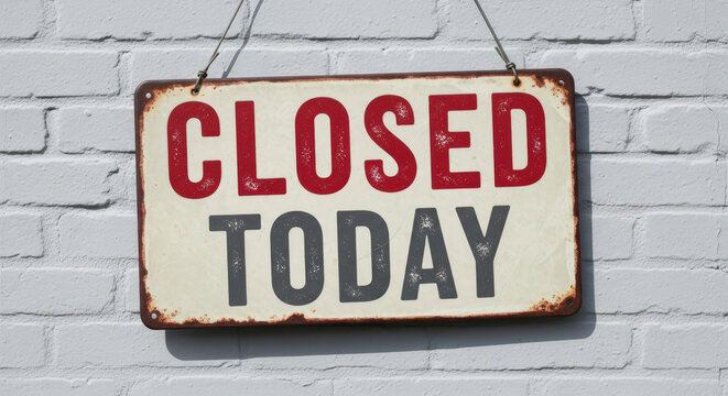 A weathered metal sign with red and grey letters displaying closed today on a white brick wall