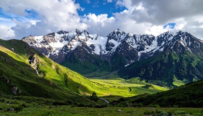 Fototapeta premium Majestic Snow Capped Mountains Rise Above A Verdant Green Valley Illuminated By Golden Sunrise Light In A Serene Landscape