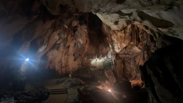 Wang Vieng, Laos.Tham Jang Cave-stalactites and stalagmites in a karst mountain with a Buddha temple inside. There is a spring inside the cave. The cave is equipped with comfortable paths and lanterns