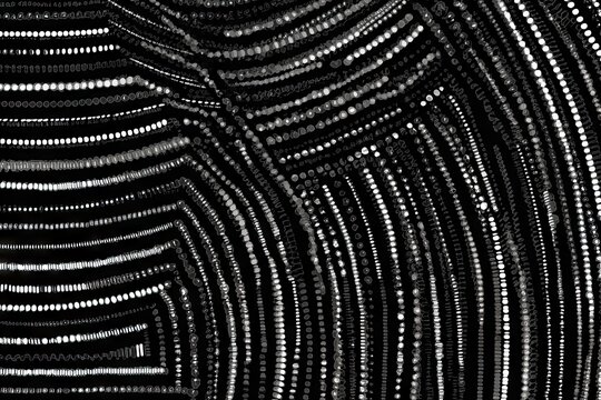 Abstract image curved lines of blurry white dots against black