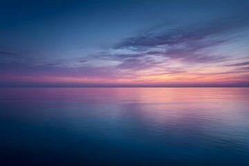 Sunset Over Calm Ocean with Gradient Sky from Pink to Deep Blue for Serene Seascape Photography