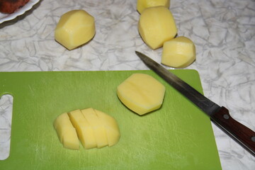 sliced potatoes on a green board