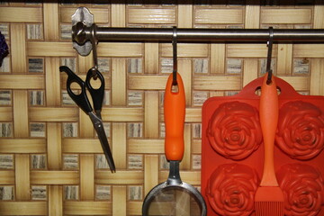 kitchen items are hung on the wall on hooks