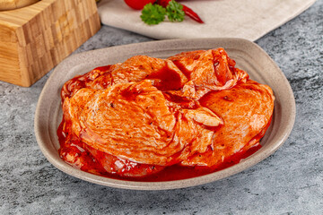 Raw chicken marinated thighs with skin