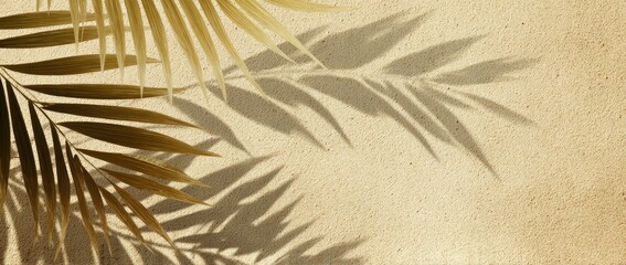Golden palm leaf shadows on beige paper