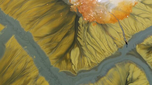 Surreal aerial view of duck trapped in colorful chemical mining leach residuals