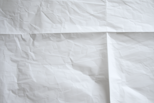 Crumpled white paper with multiple folds, textured and wrinkled surface suitable for artistic backgrounds or conceptual design projects.