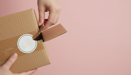 One person delivery package opening e commerce moment on pink background